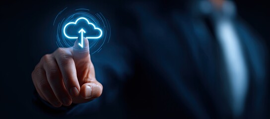 Businessman touching a glowing blue cloud computing icon for data transfer and storage.
