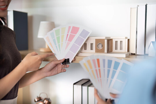 Color Palette Selection. Designers choosing colors for a project in a creative workspace.