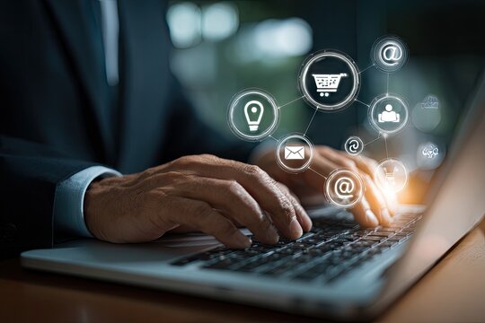 Businessman hands typing on a laptop with glowing digital marketing and e-commerce icons.
