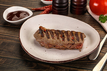 Grilled beef striploin steak with sauce
