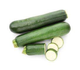 Whole and cut fresh zucchinis isolated on white, top view