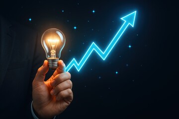 A hand holding a glowing lightbulb, overlaid with a vibrant blue upward trend graph against a dark backdrop, signifies innovation and growth.