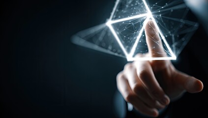 Hand touching glowing futuristic pyramid, symbolizing innovation and digital connection.