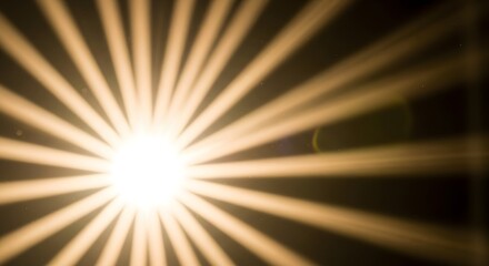 Bright golden light source emitting numerous radiant rays against a dark background, creating a starburst effect.