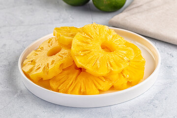 Sweet canned pineapple slices in syrope
