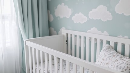 A white baby crib sits in a softly lit room with a wall covered in pale blue wallpaper featuring white cloud patterns. A sheer curtain hangs in the background, partially obscuring a window. 