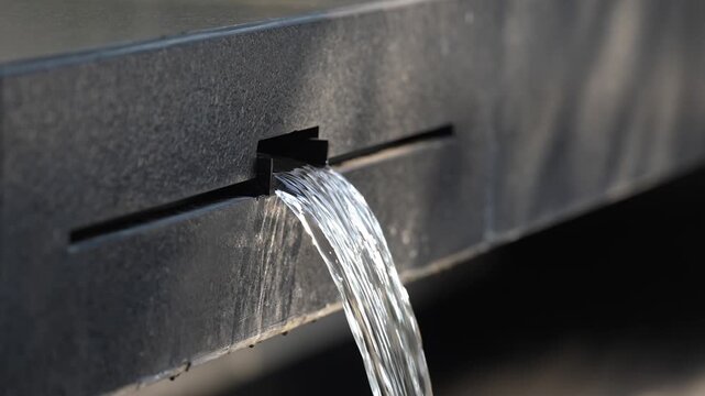 Water streams from a dark fixture