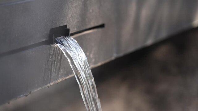 Water streams from a dark fixture