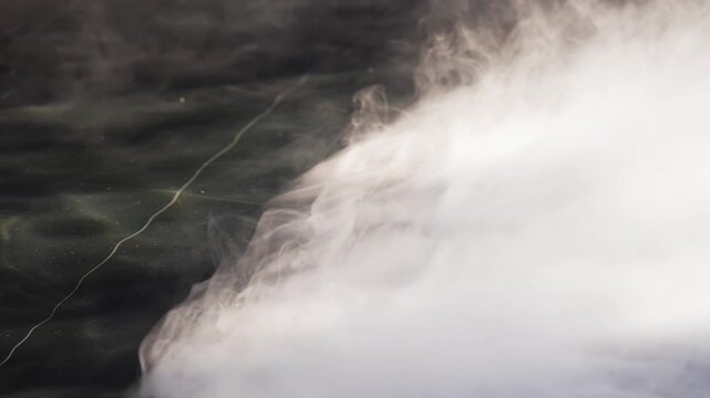 Water streams from a dark fixture