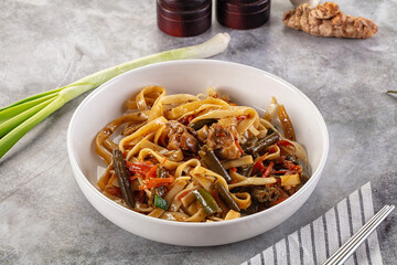 Asian cuisine udon with chicken and vegetables