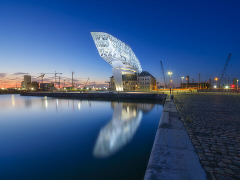 Port Authority of Port of Antwerp-Bruges. Modern main building of the port in Antwerp, Belgium. Evening urban architectural landscape. View during sunset. Background, postcard, wallpaper.