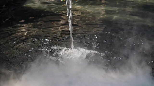 Water streams from a dark fixture