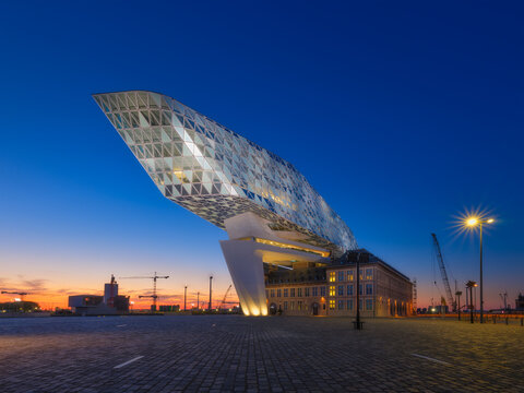 Port Authority of Port of Antwerp-Bruges. Modern main building of the port in Antwerp, Belgium. Evening urban architectural landscape. View during sunset. Background, postcard, wallpaper.