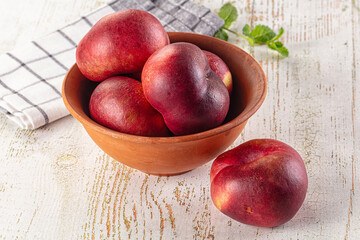 Ripe sweet juicy flat nectarines heap