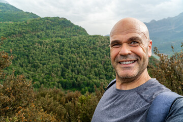 Smiling hiker taking a selfie in the mountains 