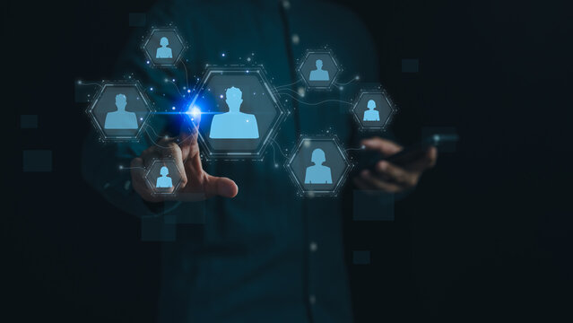 Digital networking and human connection concept. Person touchscreen interface with virtual icons of people, symbolizing social networks, online communication, HR technology and business collaboration.