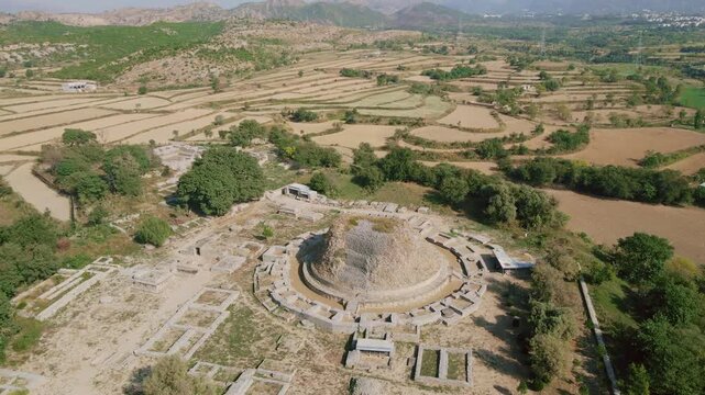 Aerial view of the Dharmarajika Stupa remains surrounded by arid landscape, revealing the ancient architecture, Taxila, Punjab, Pakistan.