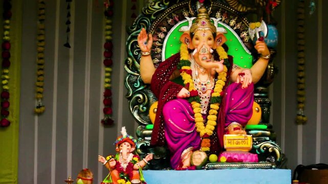 Lord Ganesha beautiful idol decorated with garlands and ornaments during Ganesh Chaturthi celebration. Perfect for cultural, spiritual and festive themes.
