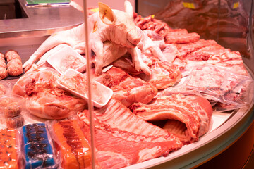 Meat department of supermarket - raw pig carcasses are on display in refrigerator