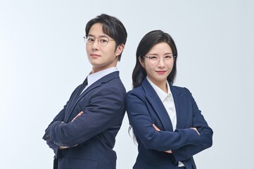 Confident Asian Male and Female Business Professionals Standing with Arms Crossed