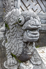 Close-up of ornate stone guardian creature sculpture with glossy eyes at Khai Dinh Tomb in Hue Vietnam