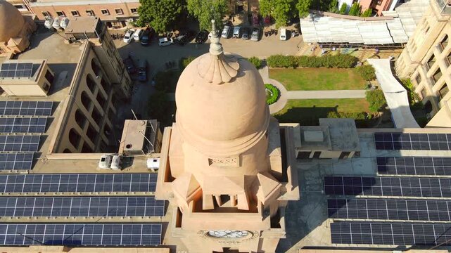 Aerial view of the Sindh Assembly Building's dome and solar panels, showcasing a blend of historic architecture and sustainable energy, Karachi, Sindh, Pakistan.