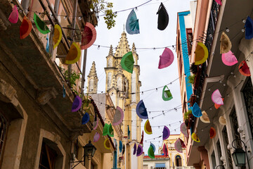 Naklejka premium Low angle view of cute garland of fans and lights in a historical city center street, Havana, Cuba