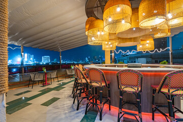 Contemporary roof top bar and cityscape view at twilight.