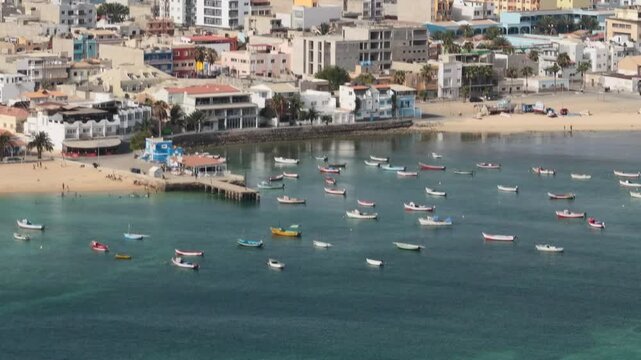Close up view of the city of Sal Rei, luxury yachts and fishermen boats moored in the port, Old city with many colorful house,Boa Vista, Cape Verde