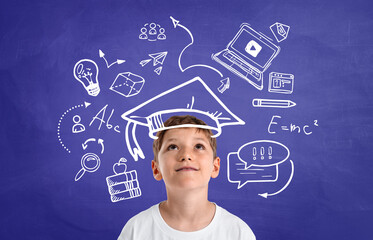 Naklejka na ściany i meble Kid imagining education with doodles on chalkboard background in