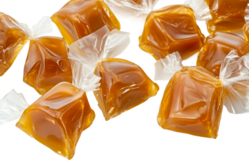 Individually wrapped golden caramels isolated on transparent background