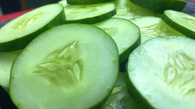fresh cucumbers. chopped cucumbers rotating with ketchen background