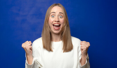 feeling shocked, excited and happy, laughing and celebrating success, saying wow!