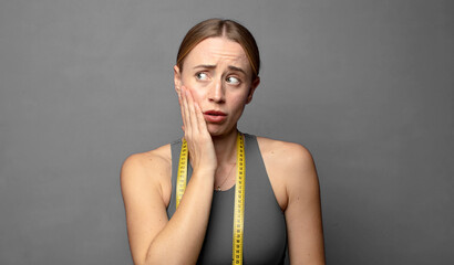 feeling shocked and astonished holding face to hand in disbelief with mouth wide open. fitness...