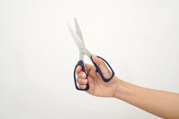 Female hands holding black scissors Isolated on white background. Closeup.