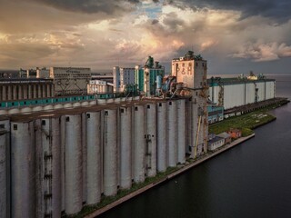 Industrial Grain Silos at Sunset © Wirestock