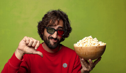 young adult bearded man. popcorns and movie concept