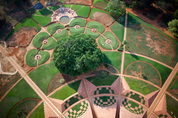 Aerial view of the meticulously designed garden with geometric patterns and a central water feature, showcasing a blend of nature and art, Bommayapalayam, Tamil Nadu, India.
