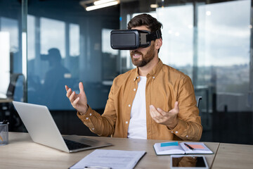 Businessman wearing virtual reality headset in modern office