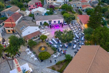 Fototapeta premium Aerial view of a vibrant Greek village square during an event.