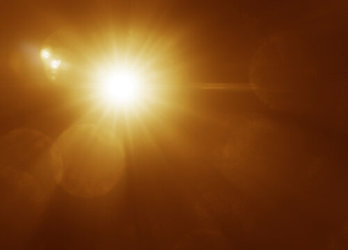 abstract photo of light burst among trees and glitter bokeh. image is blurred. yellow golden bokeh pattern background. Real optical lens flare on black backdrop. sunrays, sun rays beam, burst, sunbeam