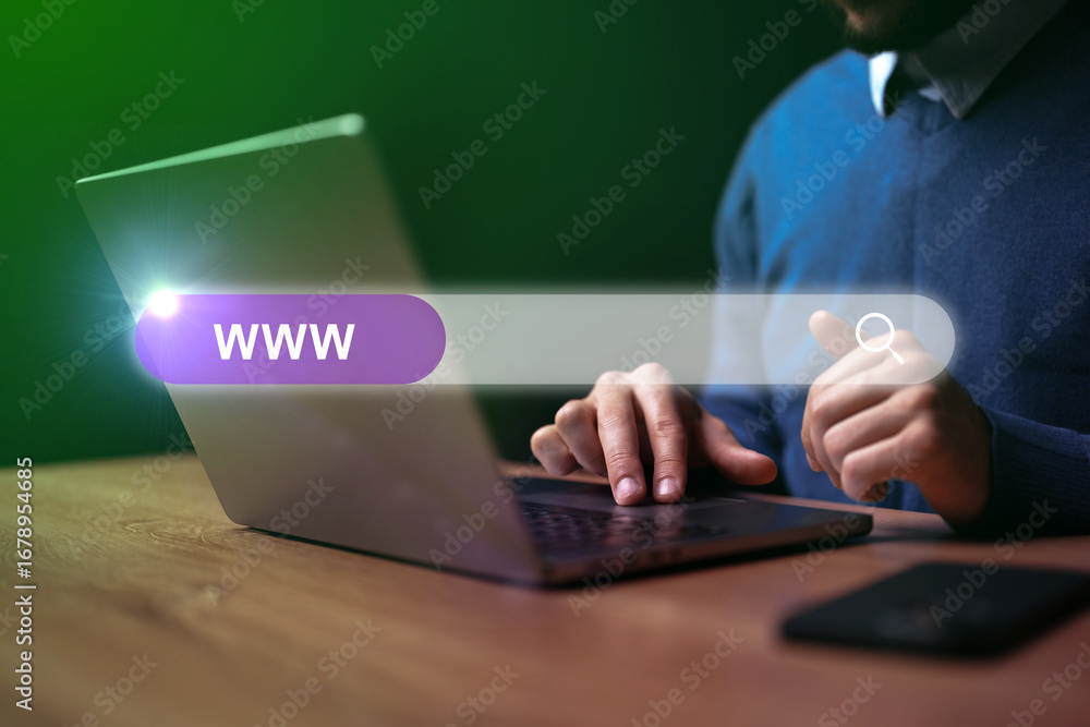 Aufkleber man browsing the internet on laptop in an indoor setting during evening hours with a focus on search