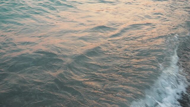 Soft waves roll onto the shore of Canj beach, where warm morning light dances on the surface of the serene Adriatic Sea as the day begins in beautiful Montenegro