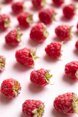 Fresh ripe raspberry with leaf on pink background, Summer fruit