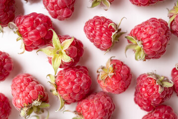 Fresh ripe raspberry with leaf on pink background, Summer fruit