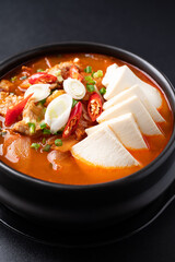 Korean food (Kimchi Jjigae), Kimchi soup with tofu, pork, scallion and chili in Korean stone bowl