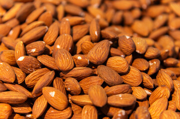 Almond background. Almonds top view background. Whole almond nuts flat lay. Full depth of field. Perfect not AI almond, true photo