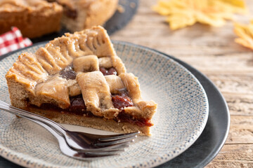 Slice of traditional Pastafrola pie with guava filling, also known as Cuban pae on rustic wooden table. Copy space