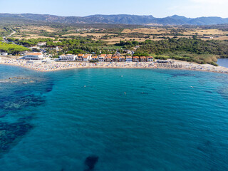 Obraz premium Aerial view of the beautiful beach of Vignola Mare with its tower