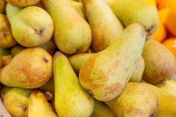 Background with bunch of ripe yellow pears. Harvest from own garden. View of pile of beautiful...